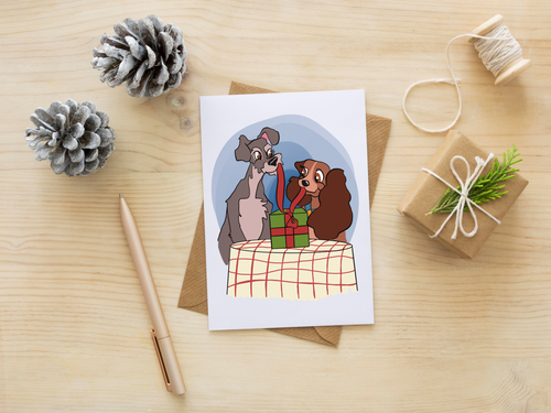 Greeting card with cartoon characters on a wooden surface with decorative items.